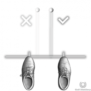 Position the ball back in your stance when hitting from a downslope